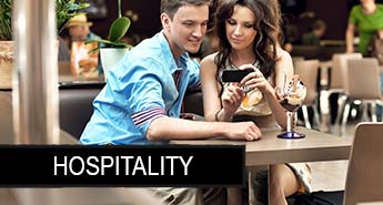 A Couple Sitting at a Table and Looking at a Cell Phone